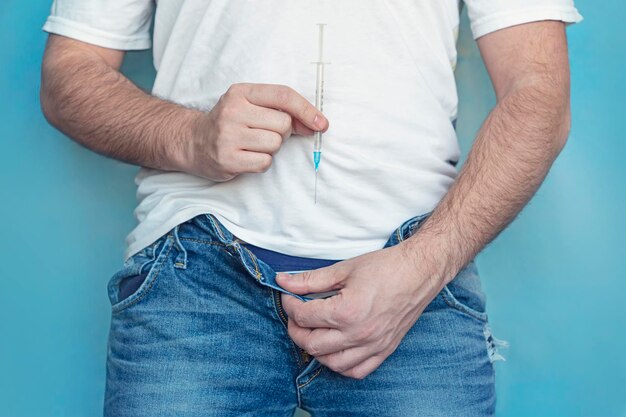 protection sexually transmitted infections man holds syringe his hands takes off his jeans concept treatment sexually transmitted diseases_431724 10623